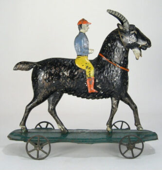 American Man Riding Goat on Wheels hand painted tin toy 1880’s