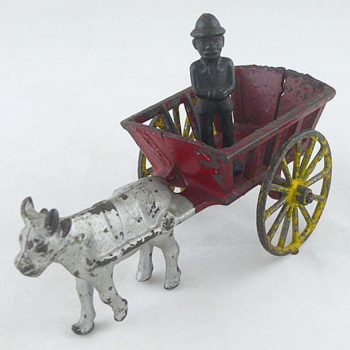 Harris Toy Cow pulling a Cart with Black Man